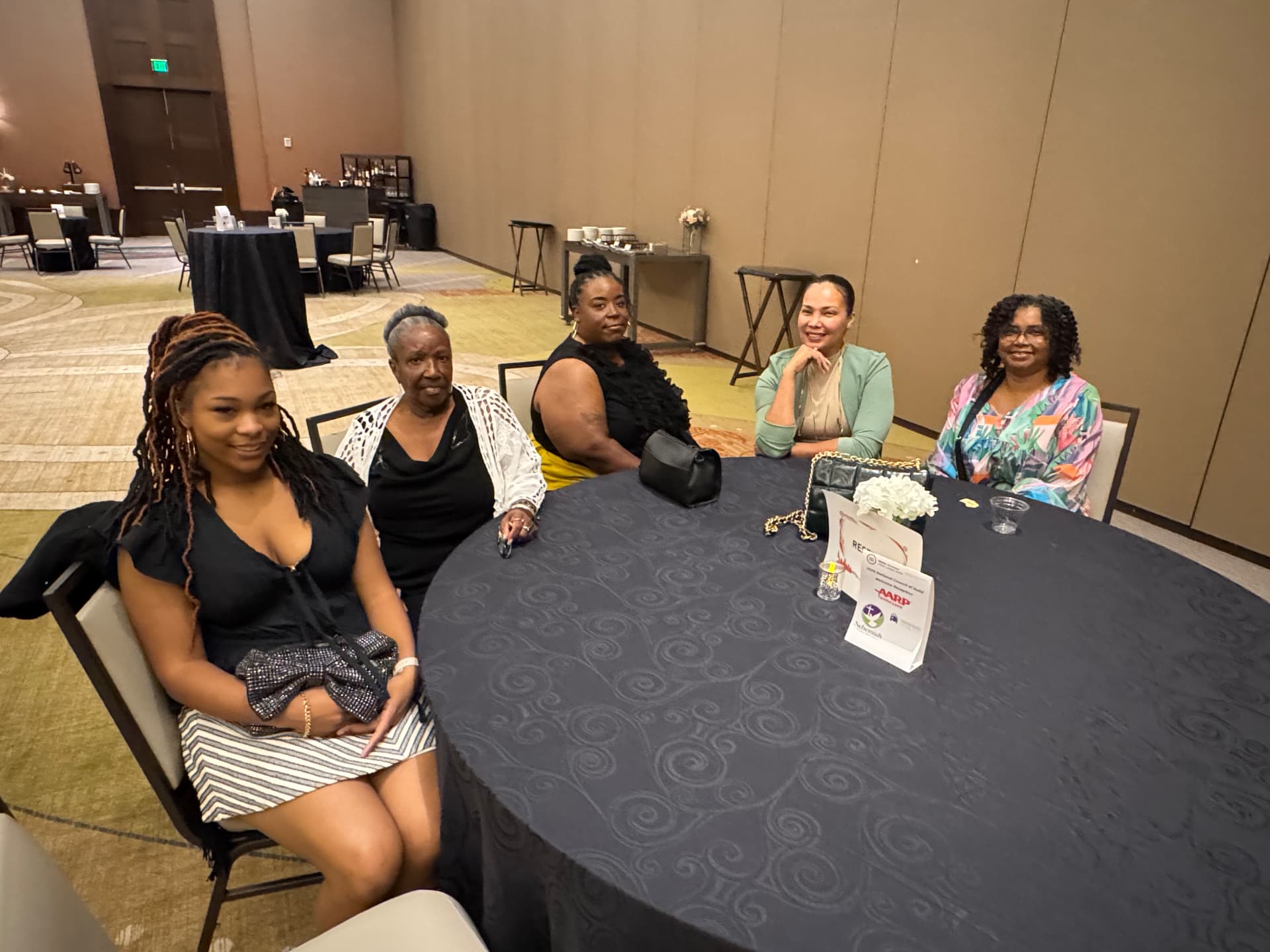 Women enjoying fellowship seated at a reception table